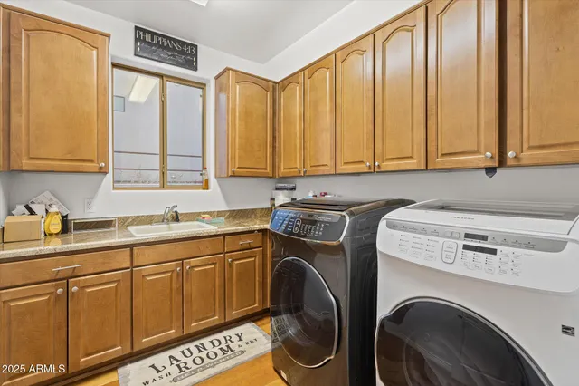 a utility room with sink dryer and washer