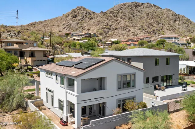 a patio with a table and chairs under an umbrella