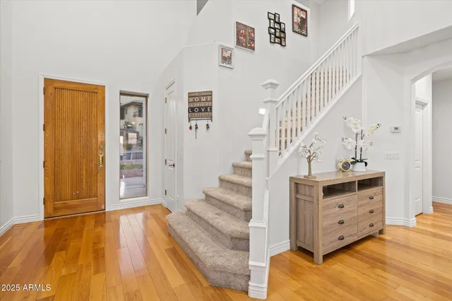 a view of entryway and hall with wooden floor