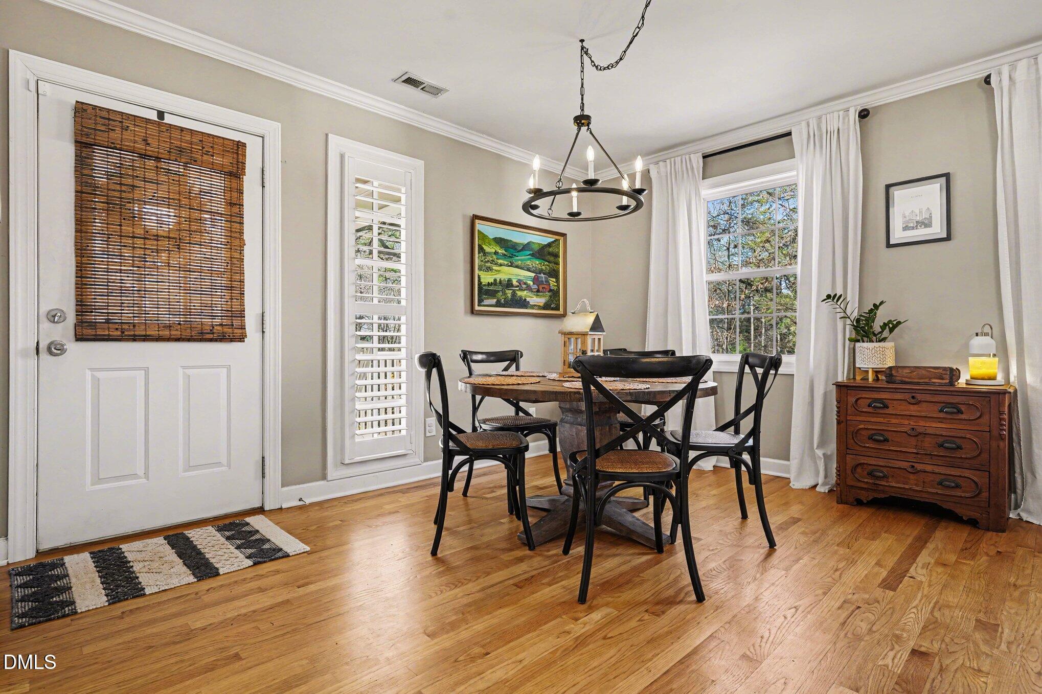 3400 Octavia Street Raleigh, NC 27606 - Photo 11 of 36 a view of a dining room with furniture window and wooden floor