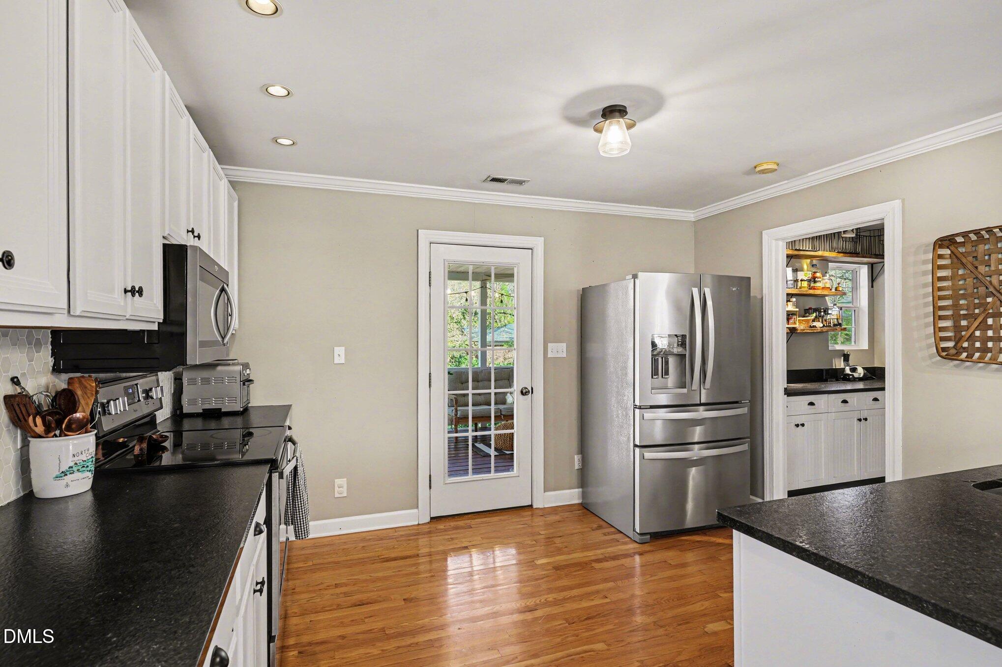 3400 Octavia Street Raleigh, NC 27606 - Photo 12 of 36 a kitchen with stainless steel appliances granite countertop a refrigerator and a stove top oven