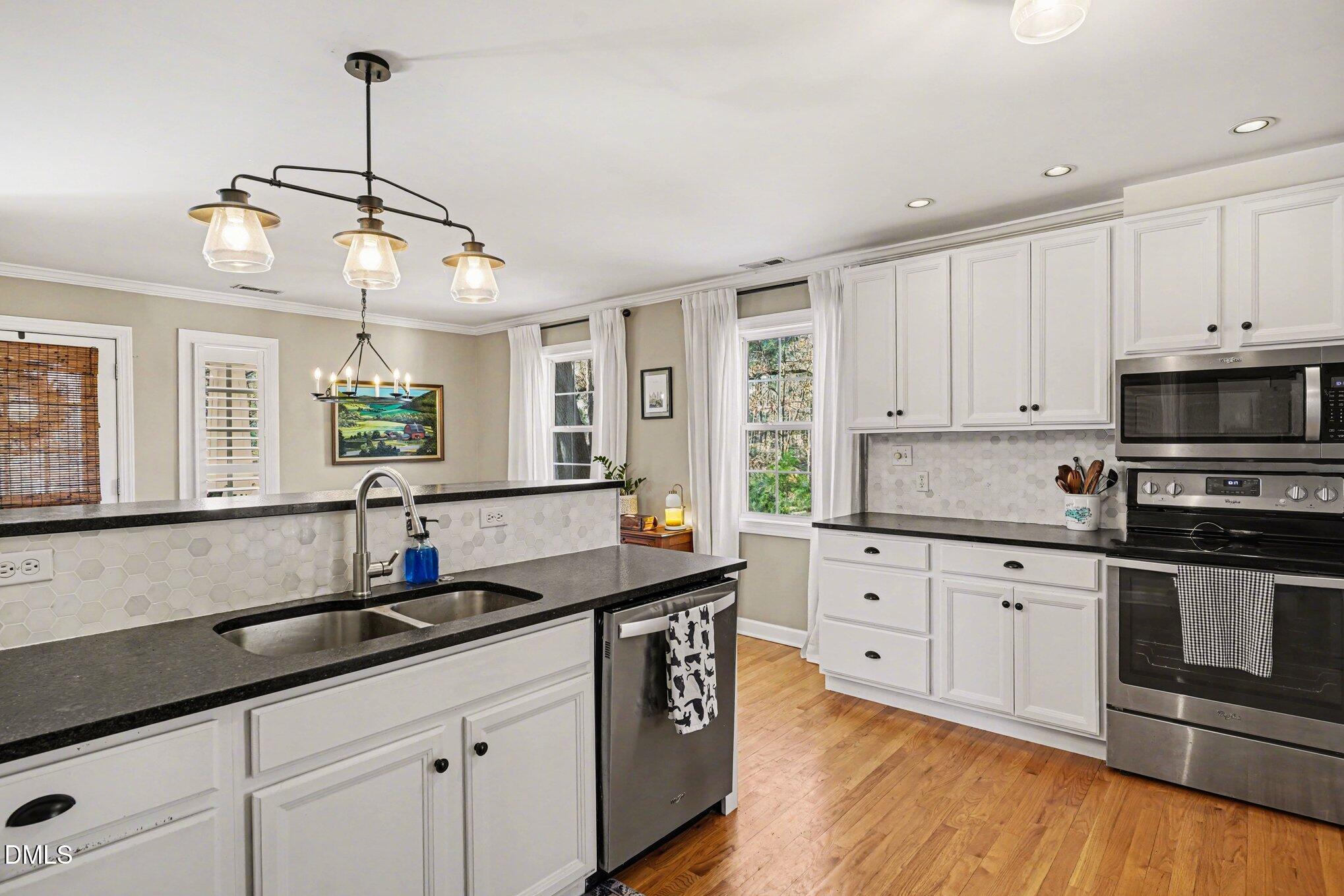 3400 Octavia Street Raleigh, NC 27606 - Photo 14 of 36 a kitchen with granite countertop a sink cabinets and stainless steel appliances