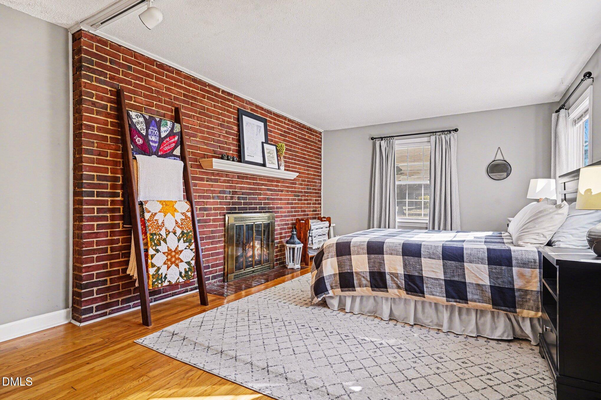 3400 Octavia Street Raleigh, NC 27606 - Photo 17 of 36 a bedroom with a bed and wooden floor