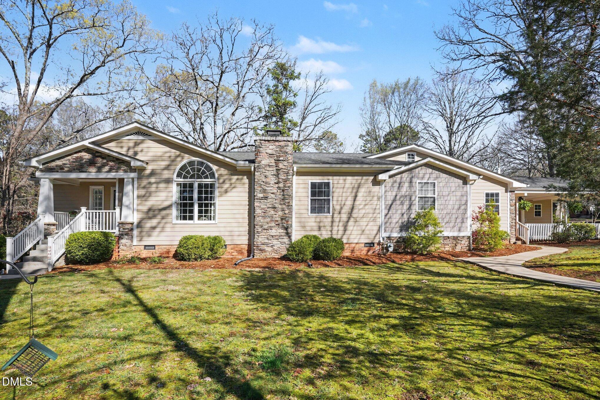 3400 Octavia Street Raleigh, NC 27606 - Photo 2 of 36 a front view of houses with yard outdoor seating and barbeque oven