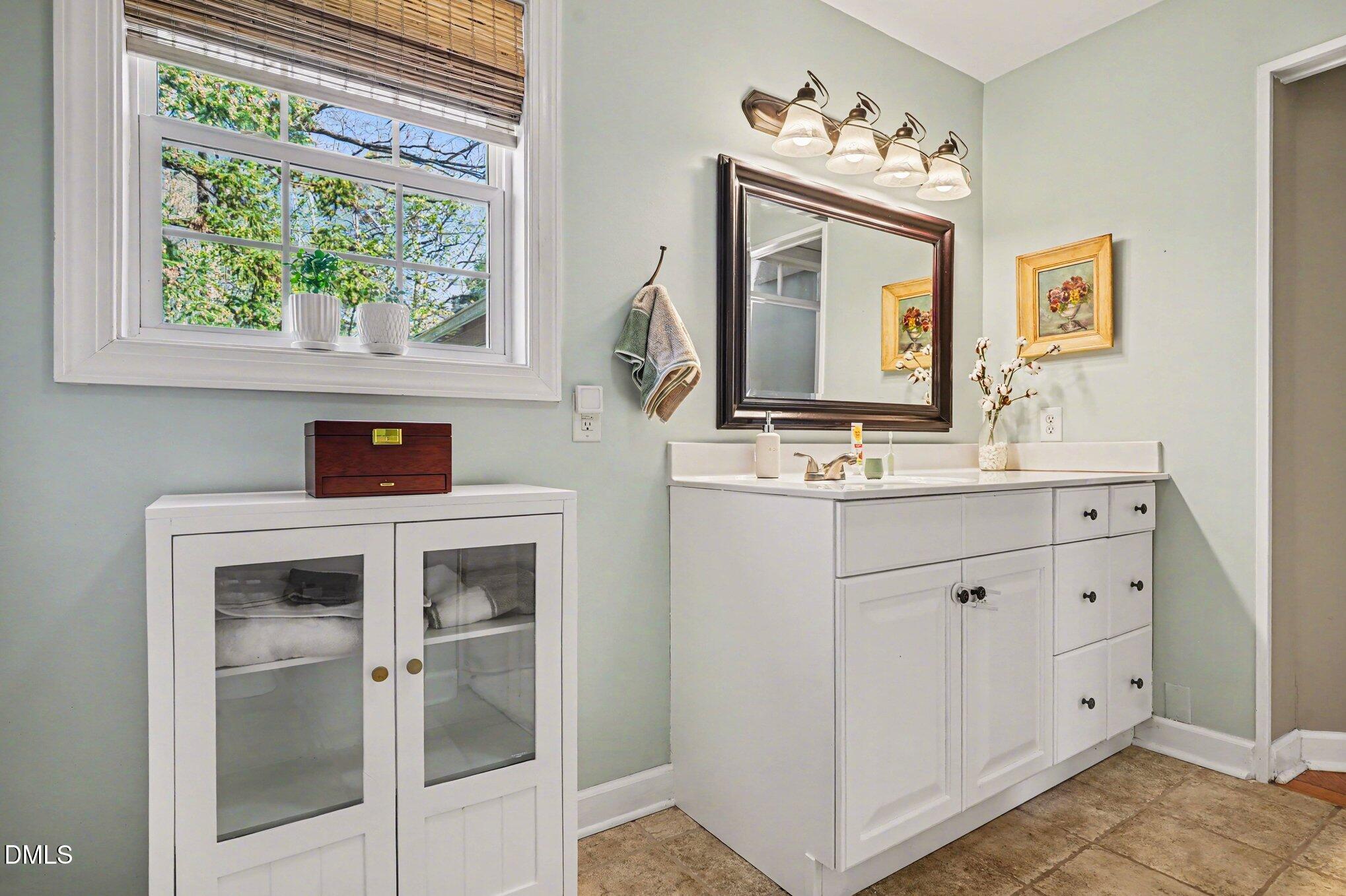3400 Octavia Street Raleigh, NC 27606 - Photo 23 of 36 a bathroom with a sink and a mirror