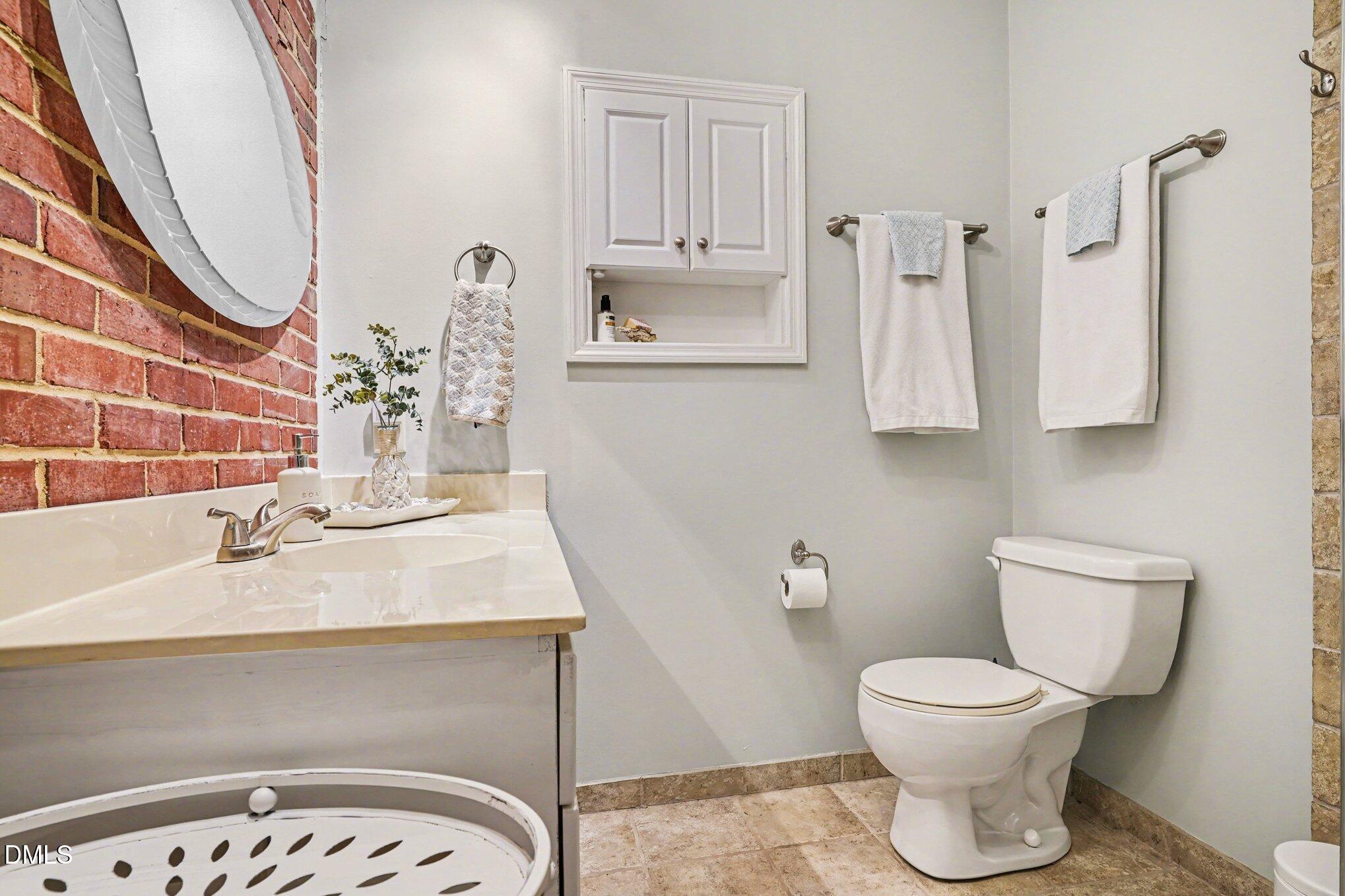 3400 Octavia Street Raleigh, NC 27606 - Photo 24 of 36 a bathroom with a sink toilet and mirror