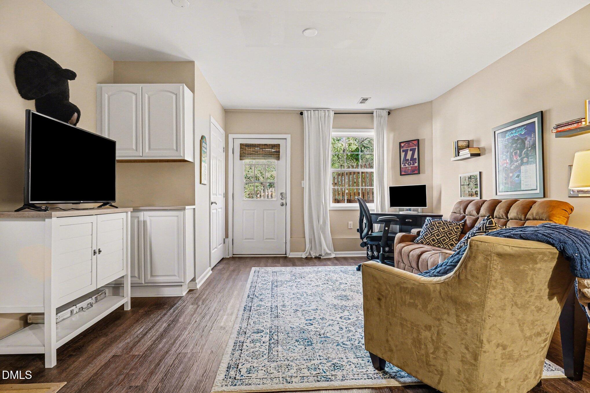 3400 Octavia Street Raleigh, NC 27606 - Photo 26 of 36 a living room with furniture and a flat screen tv