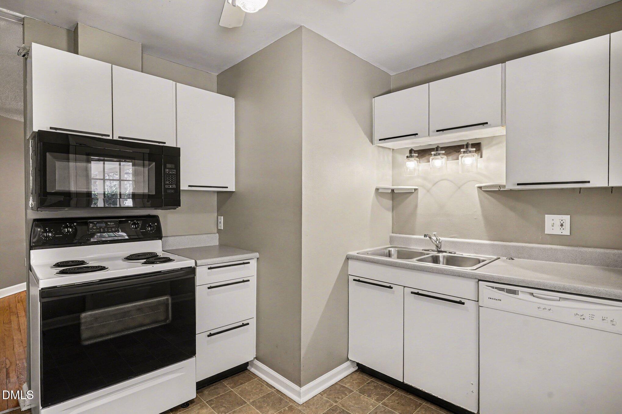 3400 Octavia Street Raleigh, NC 27606 - Photo 31 of 36 a kitchen with appliances a sink and cabinets
