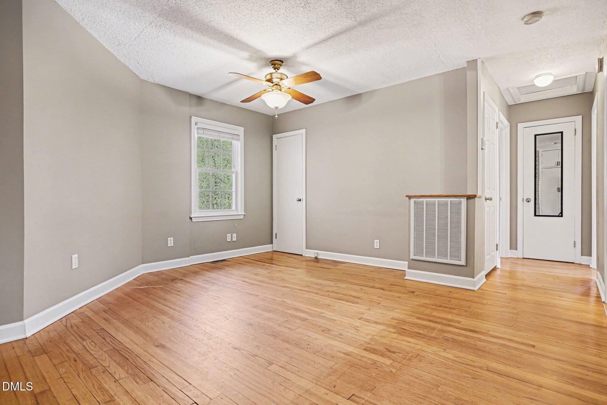 3400 Octavia Street Raleigh, NC 27606 - Photo 32 of 36 a view of an empty room with wooden floor and a window