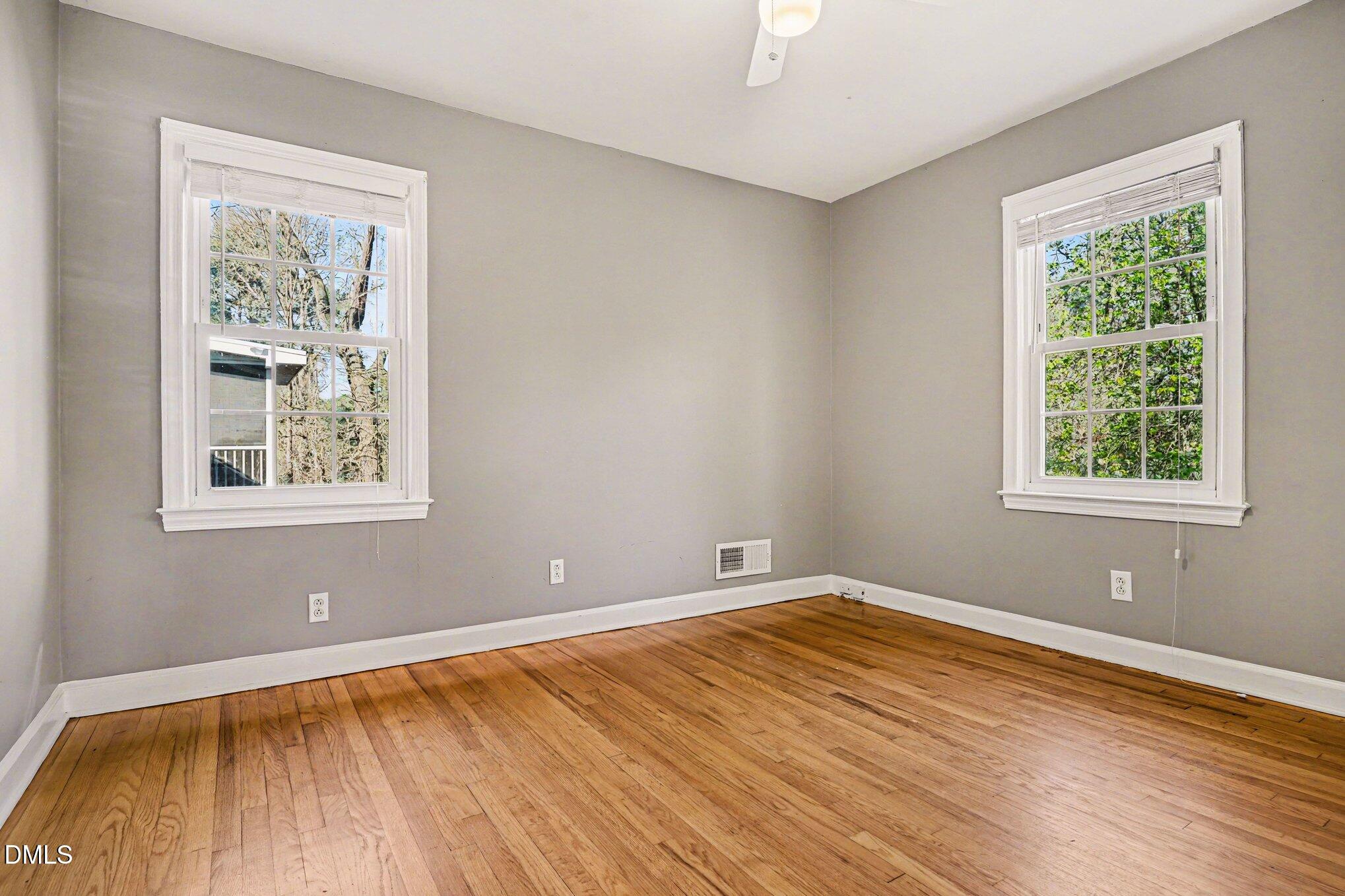 3400 Octavia Street Raleigh, NC 27606 - Photo 33 of 36 an empty room with wooden floor and windows