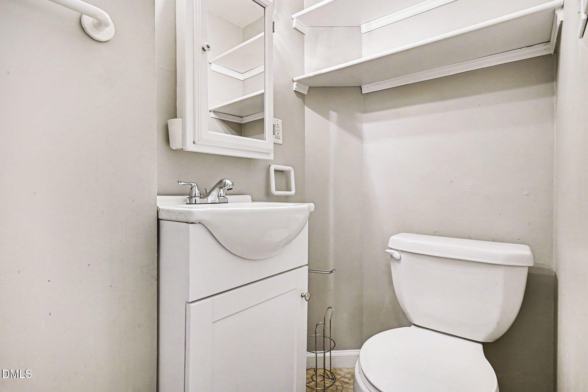 3400 Octavia Street Raleigh, NC 27606 - Photo 36 of 36 a white toilet sitting next to a bathroom sink