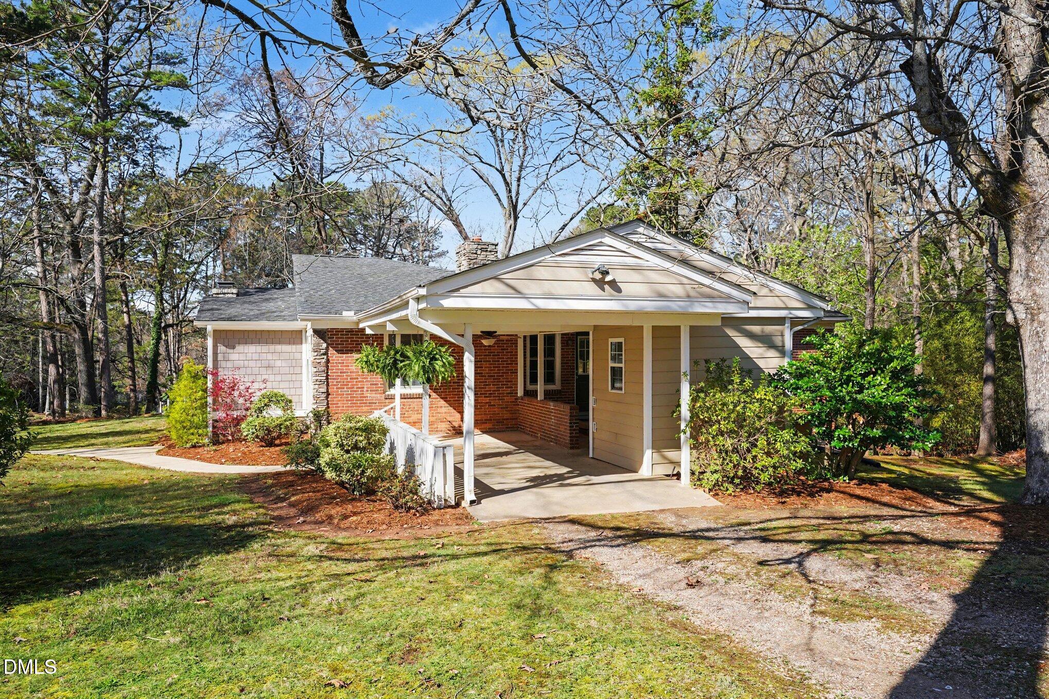 3400 Octavia Street Raleigh, NC 27606 - Photo 7 of 36 a front view of a house with a yard table and chairs