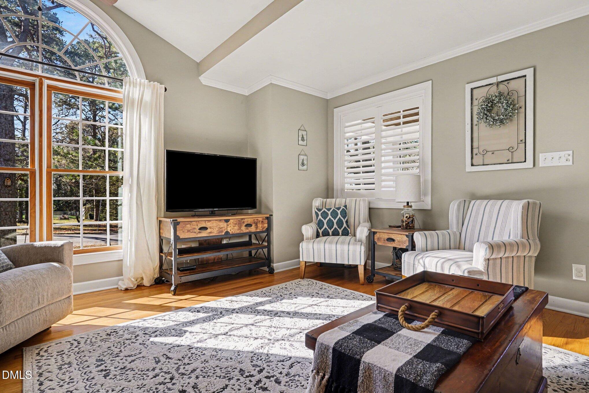 3400 Octavia Street Raleigh, NC 27606 - Photo 9 of 36 a living room with furniture and a flat screen tv