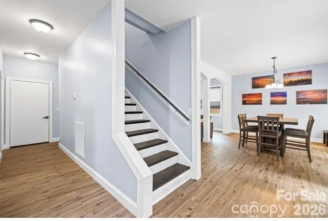a view of dining room with furniture and wooden floor