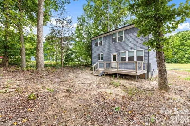 a view of a house with a yard and sitting area