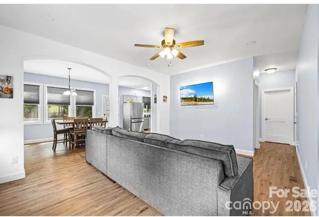 a living room with furniture and a wooden floor