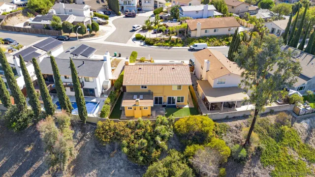 an aerial view of a house with a yard
