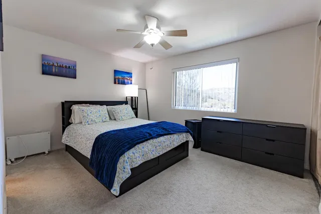 a bedroom with a bed and a window