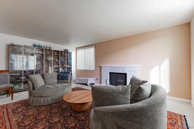 a bathroom with a granite countertop double vanity sink and a mirror