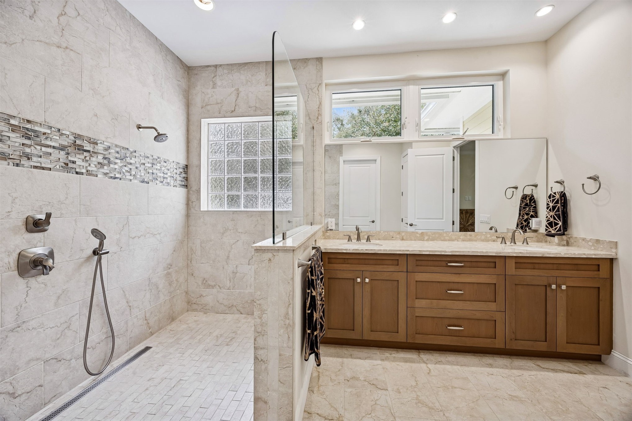 2117 Alachua Street Fernandina Beach, FL 32034 - Photo 36 of 52 a spacious bathroom with a double vanity sink a mirror and a shower