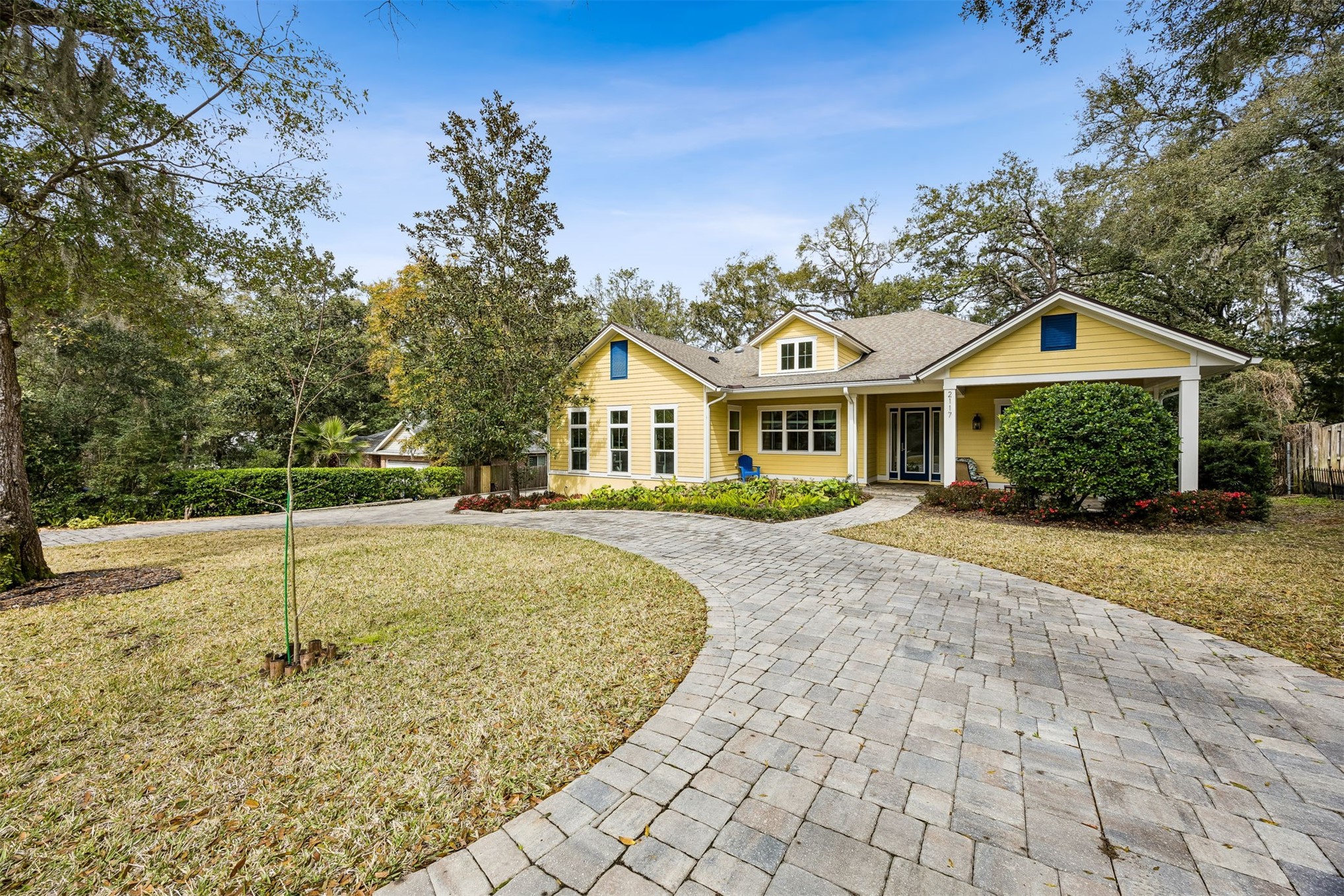 2117 Alachua Street Fernandina Beach, FL 32034 - Photo 5 of 52 a view of a white house with a small yard and large trees