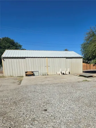 a view of a backyard with wooden fence