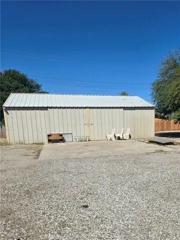 a view of a backyard with wooden fence