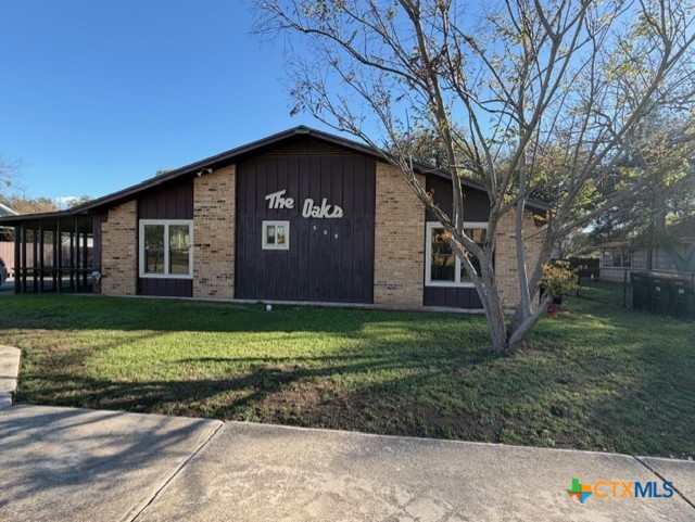 508 East Travis Street Luling, TX 78648 - Photo 1 of 17 a front view of a house with a yard