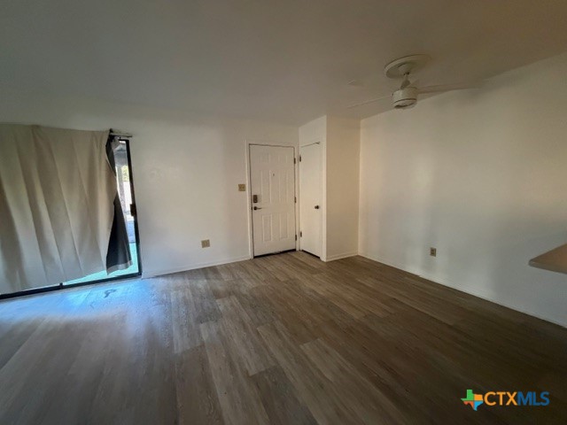 508 East Travis Street Luling, TX 78648 - Photo 12 of 17 a view of an empty room with wooden floor and a window