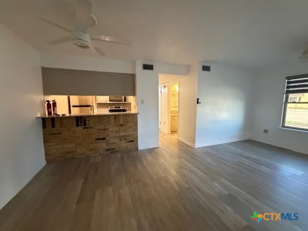 wooden floor in an empty room with a window