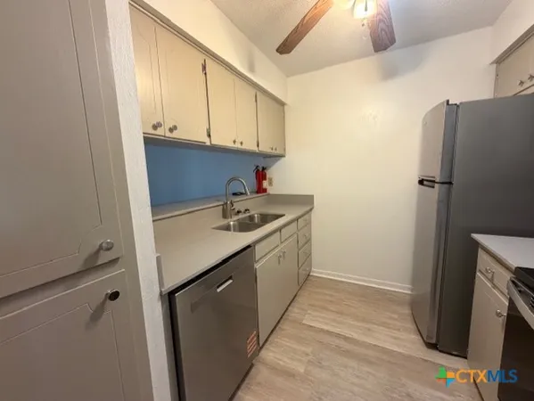 a utility room with cabinets washer and dryer