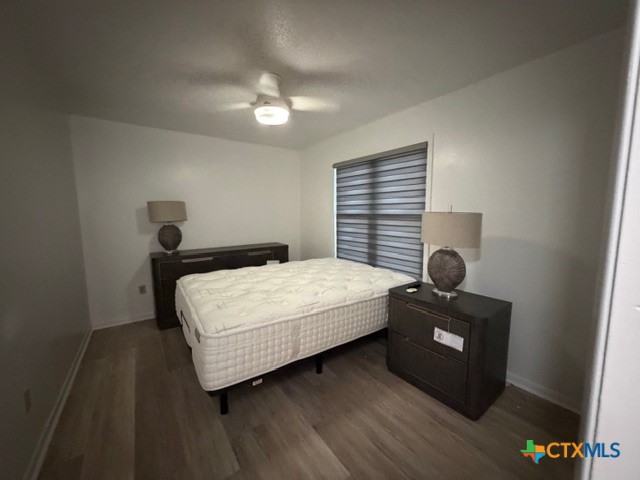 508 East Travis Street Luling, TX 78648 - Photo 10 of 17 a bedroom with a bed and a lamp on desk