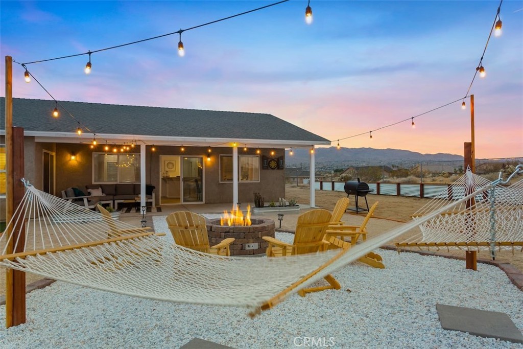 62382 Crestview Drive Joshua Tree, CA 92252 - Photo 25 of 31 a view of a patio with swimming pool table and chairs