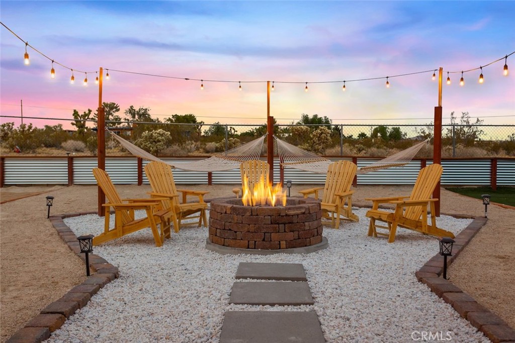 62382 Crestview Drive Joshua Tree, CA 92252 - Photo 27 of 31 a view of a terrace with furniture and a kitchen