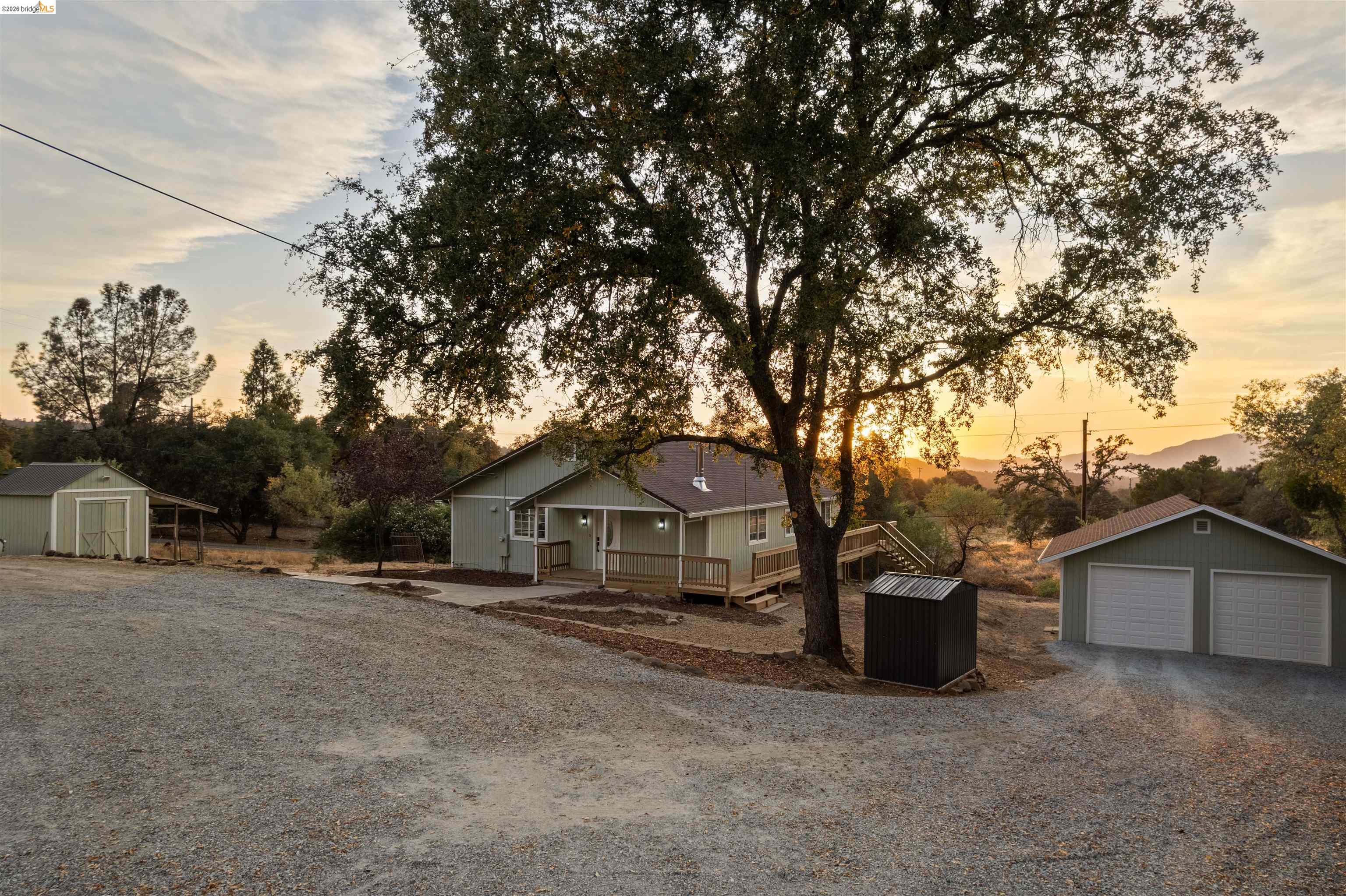 19676 Rawhide Road Sonora, CA 95370 - Photo 4 of 67 Property with gravel drive, covered front porch, detached two-car garage, and separate storage shed