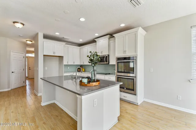 a kitchen with a sink and a potted plant