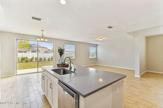 a kitchen with stainless steel appliances granite countertop a sink and cabinets