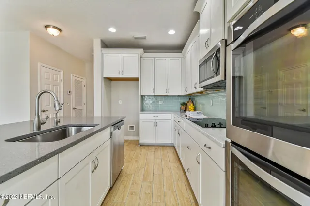 a view of a kitchen with a stove cabinets and wooden floor