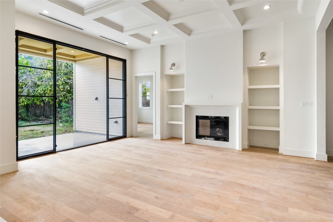 1002 East 25th Street Houston, TX 77009 - Photo 15 of 45 a view of an empty room with a fireplace and a window