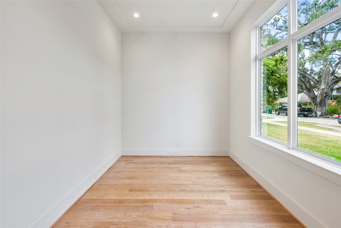 1002 East 25th Street Houston, TX 77009 - Photo 19 of 45 a view of an empty room with wooden floor and a window