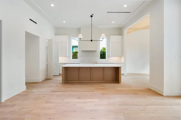 a view of a kitchen with wooden floor and a sink