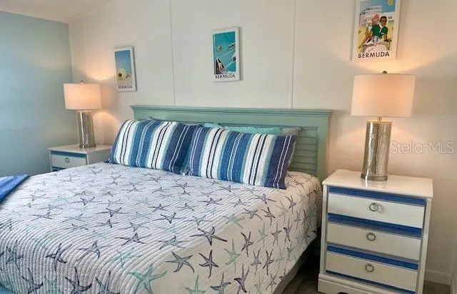 a bedroom with a bed and a lamp on table