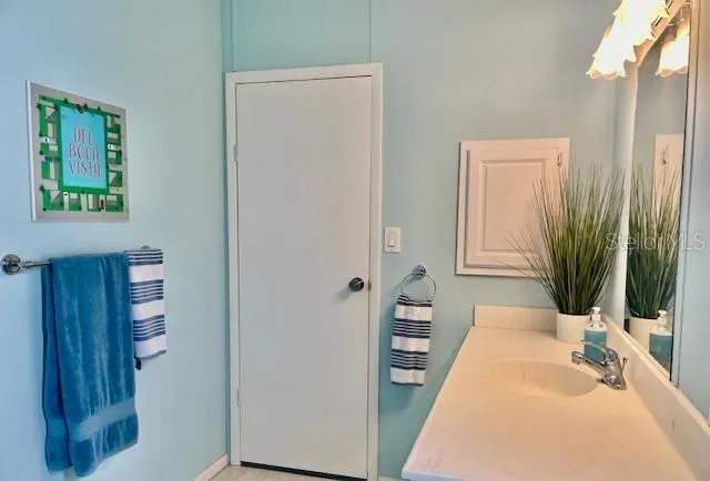 a spacious bedroom with a bed and a mirror