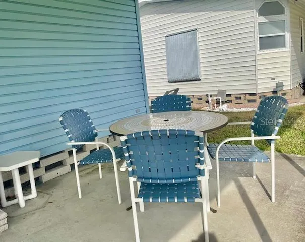 a view of a chairs and table in the balcony