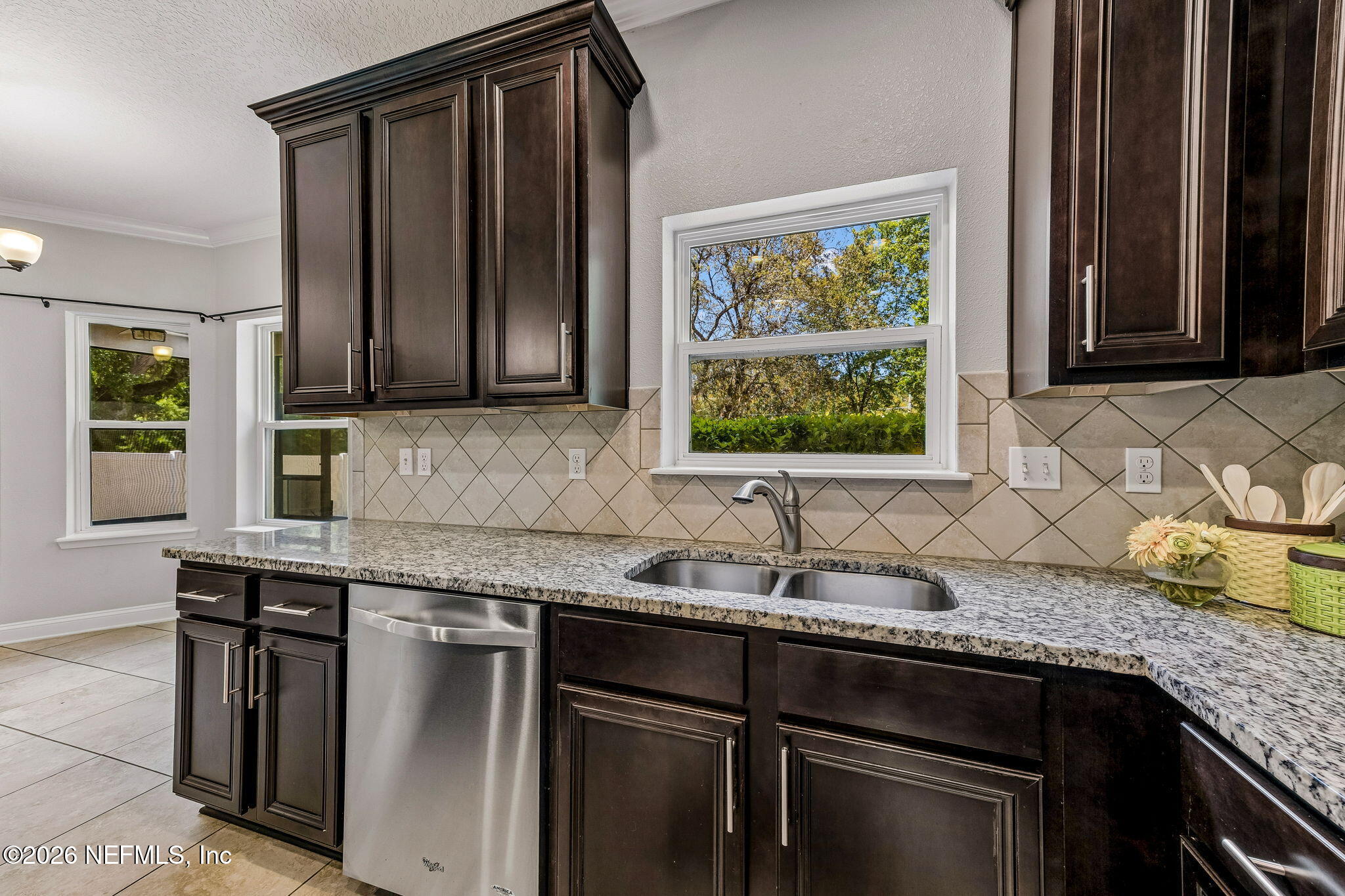 12198 Ridge Crossing Way Jacksonville, FL 32226 - Photo 16 of 67 a kitchen with granite countertop stainless steel appliances a sink window and cabinets