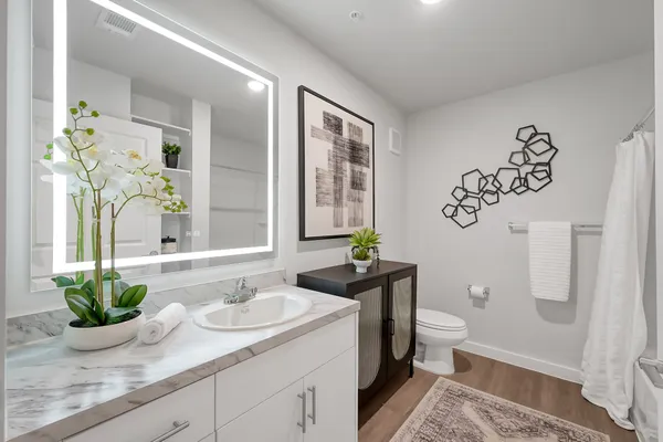 a bathroom with a granite countertop sink and a mirror