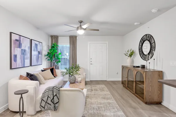 a living room with furniture and a large window