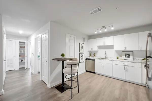 a kitchen with white cabinets and stainless steel appliances