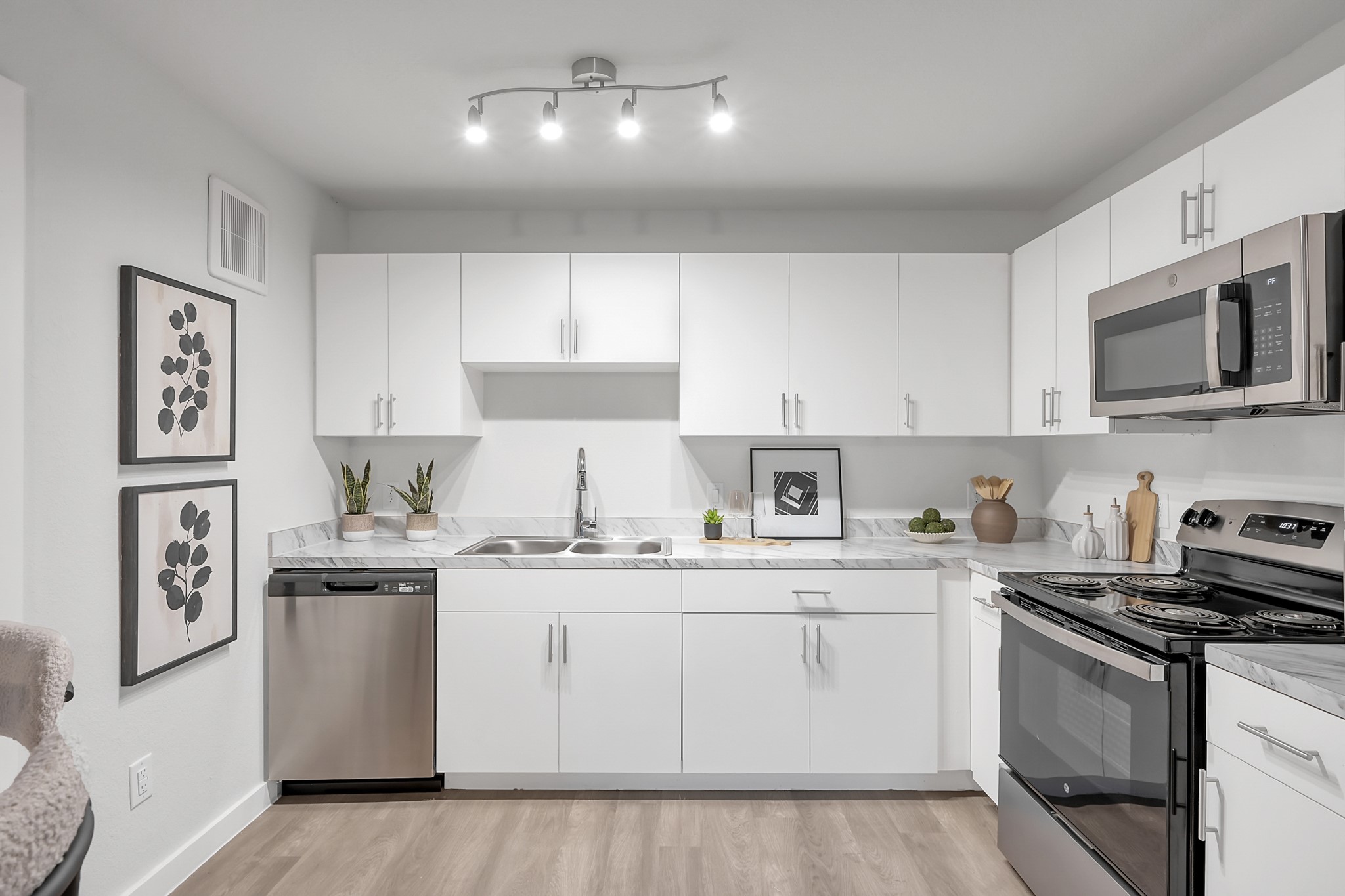 3450 Barker Cypress Road, Unit 2201 Houston, TX 77084 - Photo 6 of 17 a kitchen with stainless steel appliances granite countertop a sink and cabinets