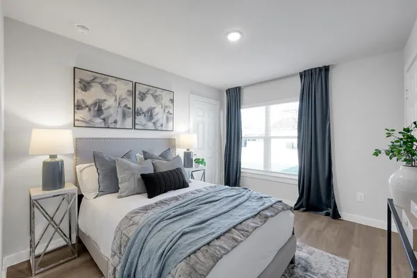 a bedroom with a bed and a painting on the wall